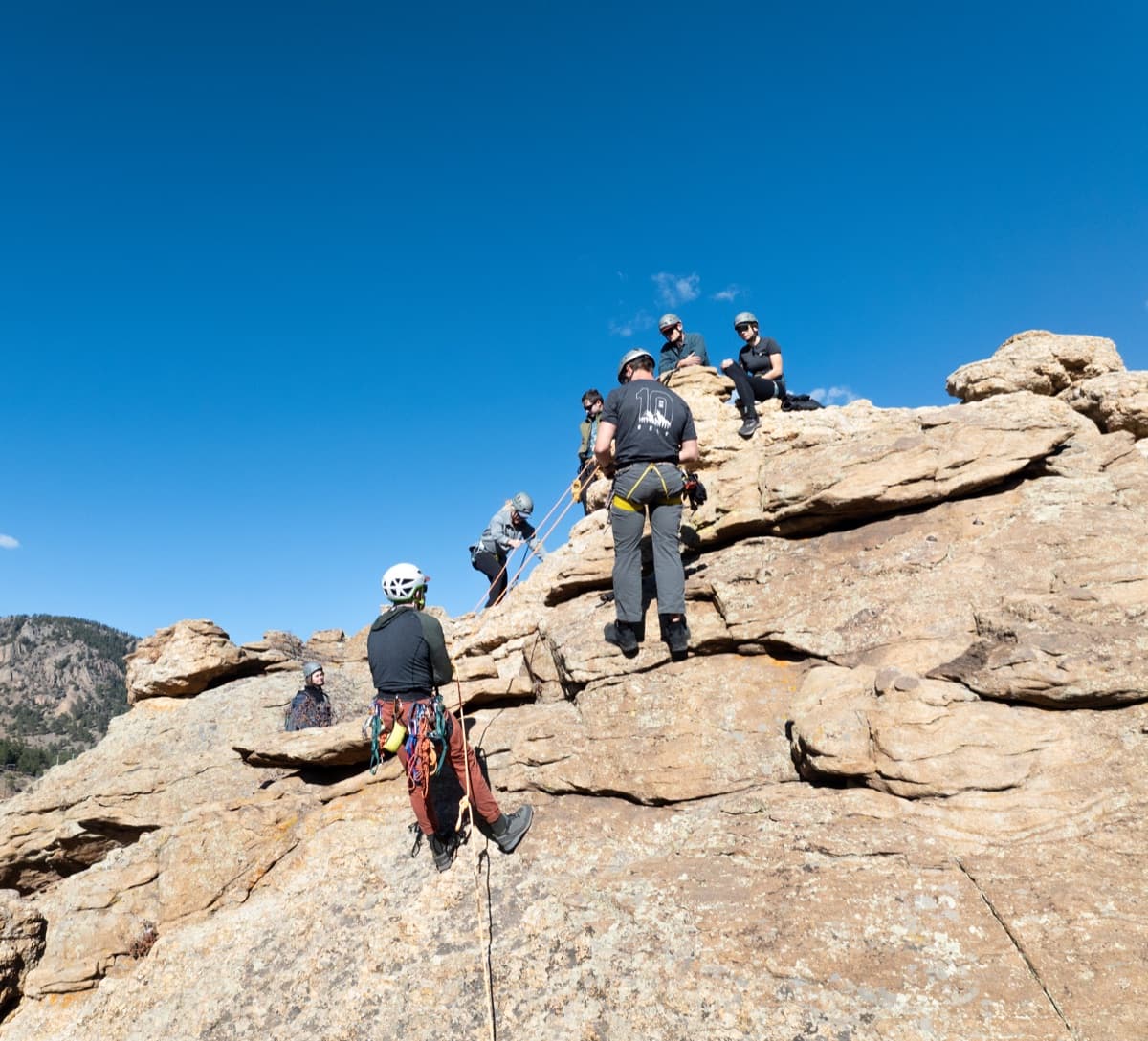 A veteran mentor and students at a summit